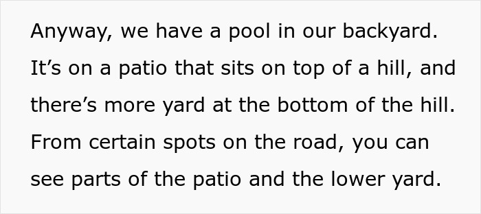 A person wearing bikini relaxing in their own yard near a pool on a patio with views of the lower yard and road.