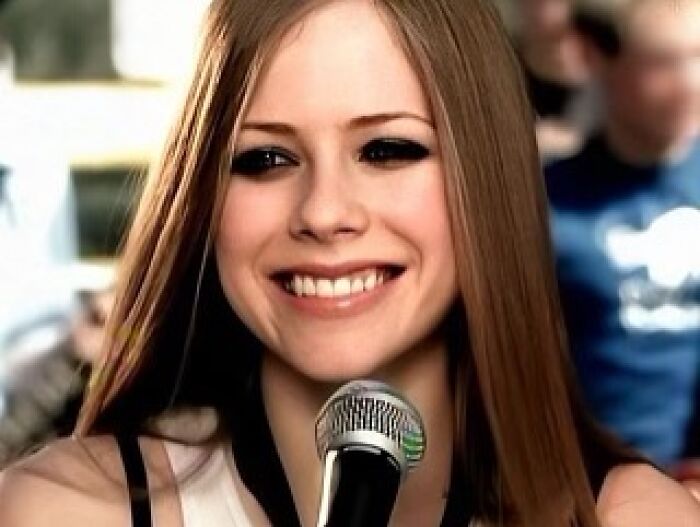 Young woman smiling while speaking into a microphone, reflecting moments hiring managers deal with the worst people.