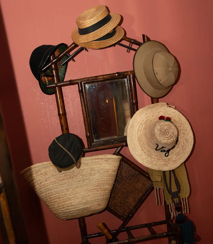 Hat rack with various hats and bags hanging, related to wedding photographer and bride's critique.