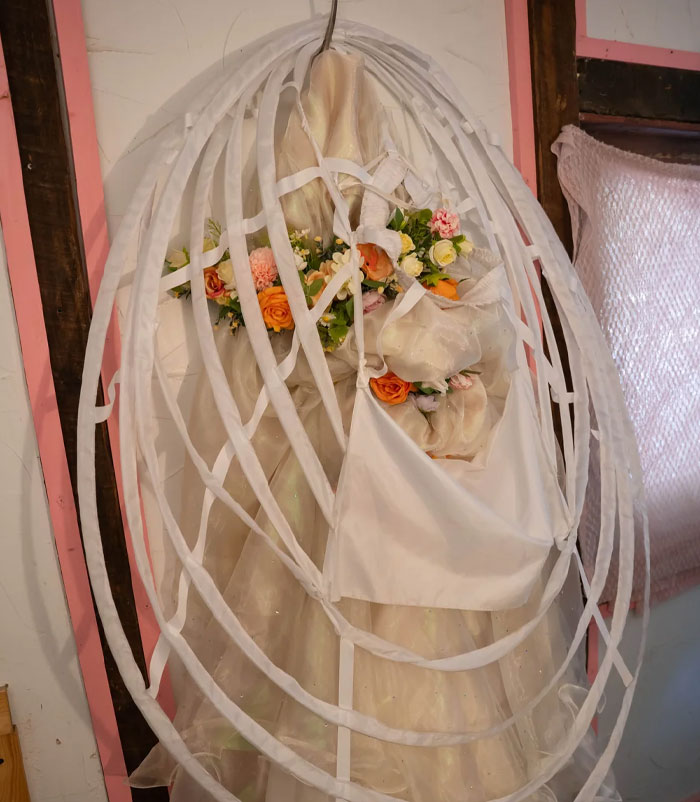 Wedding dress on display with floral bouquet, illustrating a bride's critique of a $3K wedding photographer.