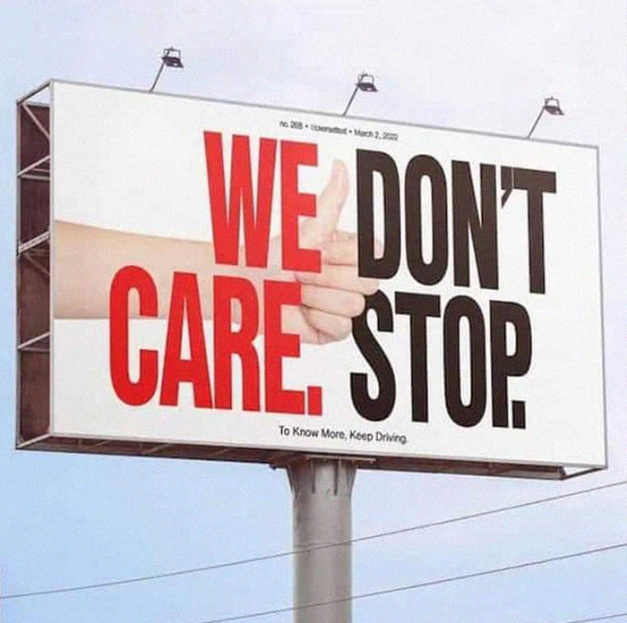 Billboard design fail with confusing hand image and bold text saying We Care Don't Stop, illustrating design fails.