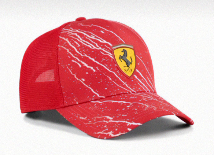 Red cap with white splatter design and a Ferrari logo showing a notable example of design fails approved for production.