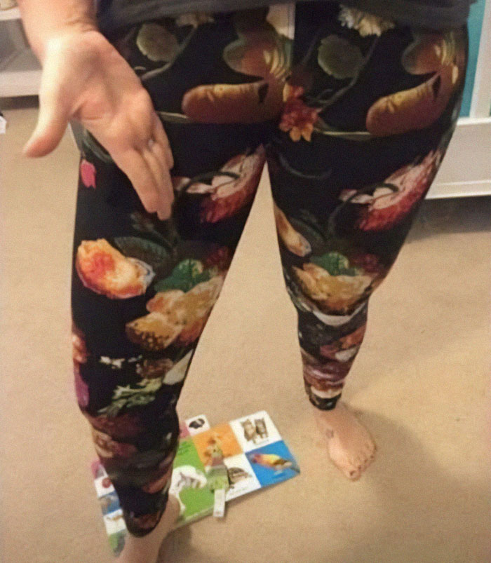 Person wearing floral leggings with a design fail where the c****h area print creates an unintentional awkward visual effect.