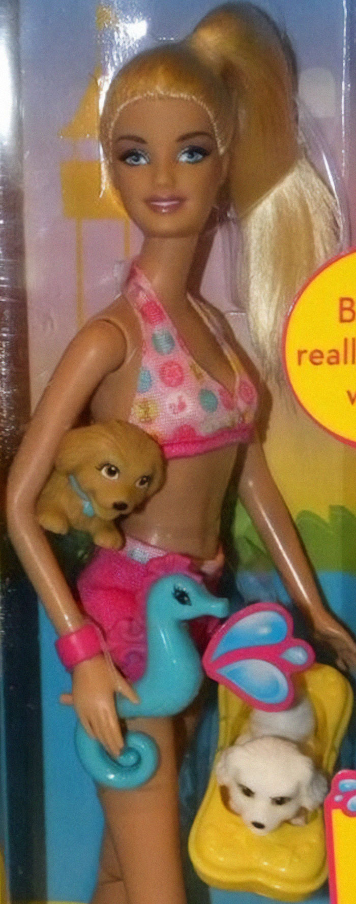 Doll with exaggerated neck holding a puppy and a blue seahorse toy, showing a clear design fail in product creation.