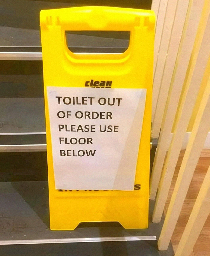 Yellow caution sign with a confusing notice about an out of order toilet, showcasing a design fail.