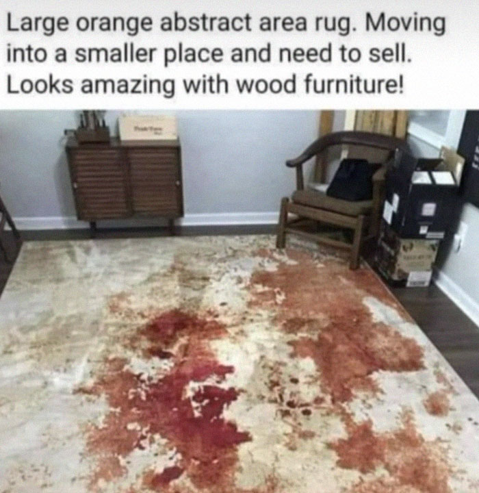 Abstract area rug with red and orange stains in a room with wood furniture, showcasing design fails that confuse buyers.