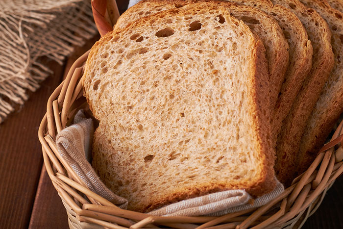 Sliced bread in a basket representing one of the biggest reverse culture shocks Americans face after moving back home.