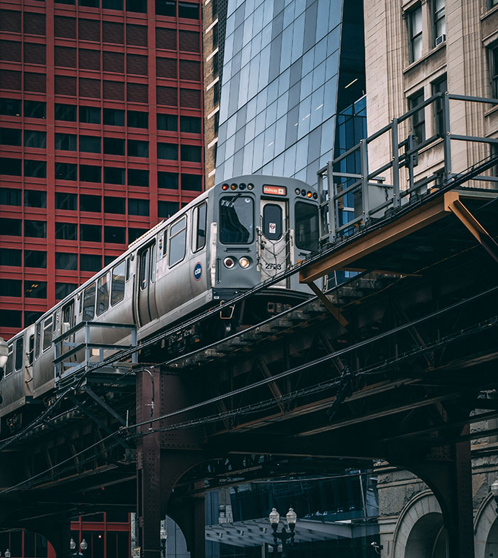 Elevated train passing through downtown cityscape, illustrating reverse culture shocks Americans face after moving back home.
