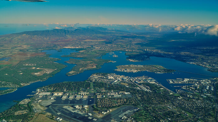 Aerial view of a coastal city and harbor surrounded by mountains, showcasing one of the biggest world unexpected discoveries.