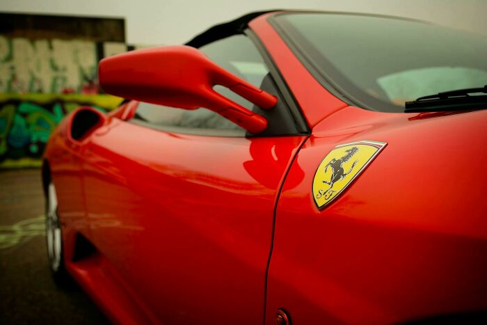 Close-up of a luxurious red sports car with a Ferrari emblem, symbolizing one of the biggest world unexpected discoveries.