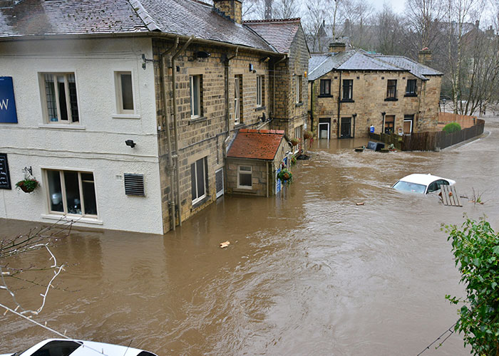 Flooded residential area showing the dangers blue collar workers face with scariest job site experiences.