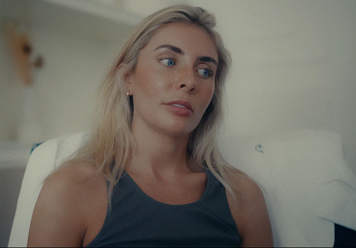 Woman with blonde hair and blue eyes changing expression, body language expert analyzing her reaction in a scandalous documentary. - 10