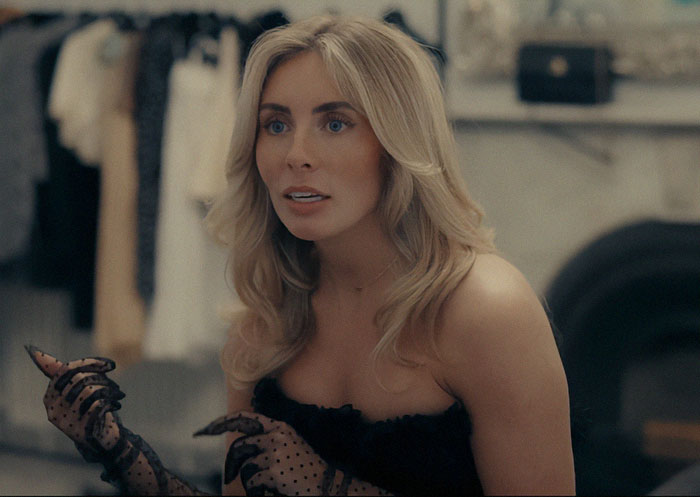 Blonde woman in black lace gloves with surprised expression as body language expert decodes sudden change in emotion. - 2