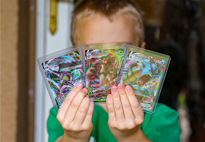 Young person displaying rare collectible cards, illustrating how profitable these 58 industries are in today’s market.