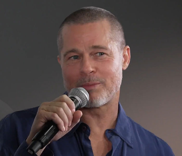 Brad Pitt speaking into a microphone during a public message that went viral following his mom's passing. Brad Pitt speaking into a microphone during a public message that went viral following his mom's passing.