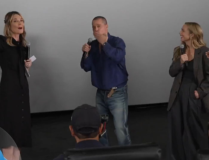 Three people speaking on stage with microphones during an event discussing Brad Pitt's final public message to his mom. Three people speaking on stage with microphones during an event discussing Brad Pitt's final public message to his mom.