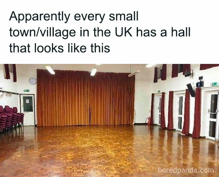 Empty village hall with wooden floor and closed curtains, illustrating a common scene in life in the UK.