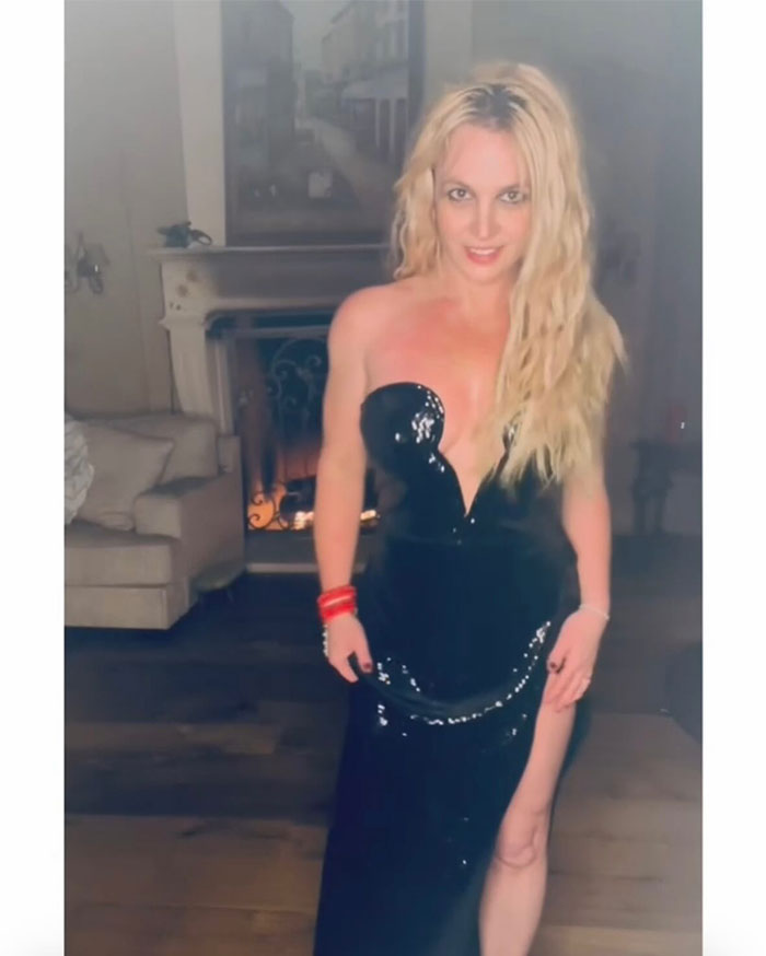 Britney Spears standing in a black sequined dress, showcasing her style and net worth in 2025 after conservatorship.