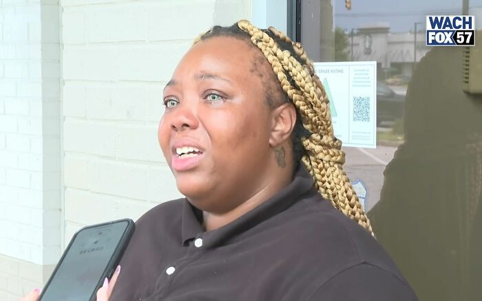 Burger King employee with braided hair speaking outside, sharing emotional update after viral 12-hour performance and firing.