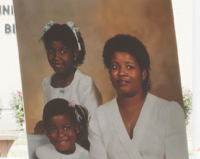 Portrait of a woman and two children inside with a blurred background, unrelated to inmate cries out during execution or defibrillator. - 2