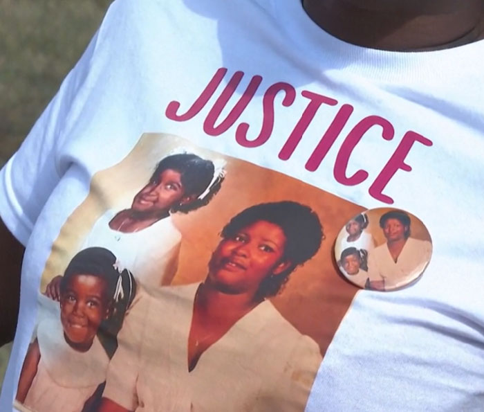 Close-up of a person wearing a justice t-shirt with family portraits, relating to inmate cries out during painful execution news. - 10
