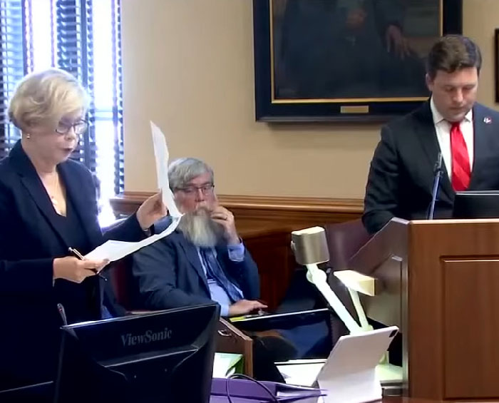 Lawyers in a courtroom discussing legal documents during a case about inmate cries out during execution procedure. - 11