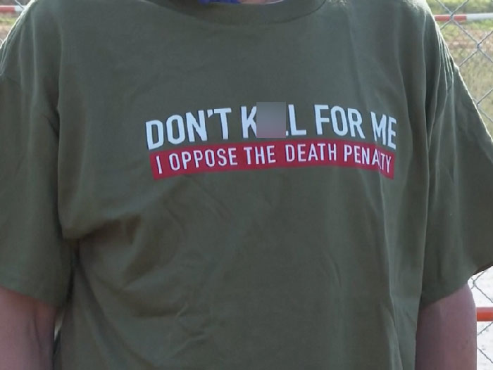 Person wearing a shirt opposing the death penalty, highlighting inmate cries during painful execution controversy. - 12