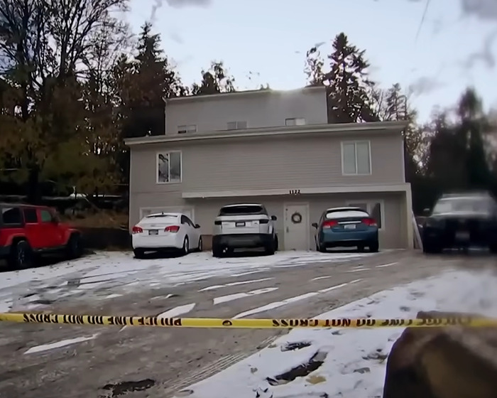 Crime scene outside a house with police tape in foreground, related to Bryan Kohberger chilling footage in jail. Crime scene outside a house with police tape in foreground, related to Bryan Kohberger chilling footage in jail.