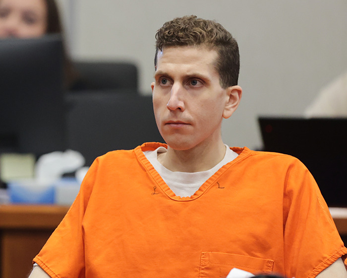 Bryan Kohberger in an orange prison jumpsuit, sitting and looking ahead during a tense jail hearing. Bryan Kohberger in an orange prison jumpsuit, sitting and looking ahead during a tense jail hearing.