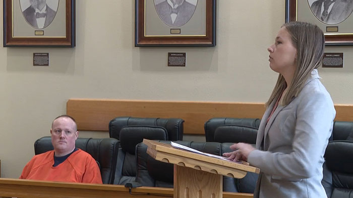 Woman in courtroom revealing details about being held captive in a soundproof bunker by stalker for 13 years.