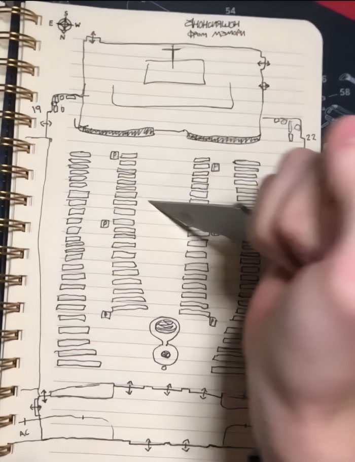 Hand holding a knife over a notebook sketch with a disturbing manifesto and photo layout linked to Minneapolis massacre culprit.