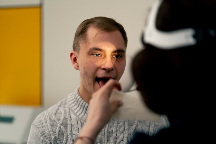 Young man having a medical checkup, illustrating a story about the smartest kids in their class and life outcomes.