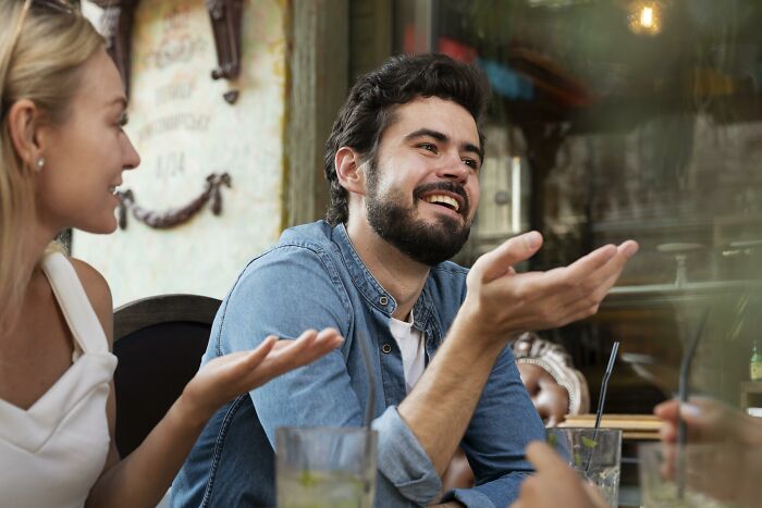 Two people having a lively conversation, illustrating non-English words used in other languages about communication.
