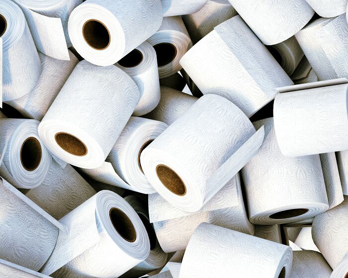 Multiple rolls of white toilet paper stacked closely together, highlighting unexpected wedding registry items.