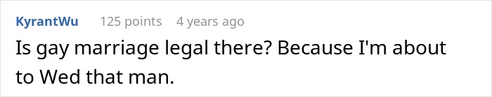 Man feeding kitten on a subway platform, showing a moment of kindness and care in an urban setting.