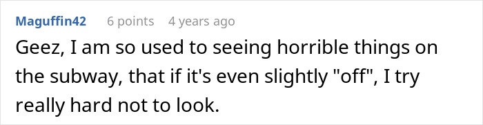 Man feeding a small kitten on a subway platform, showing kindness in a busy urban setting.