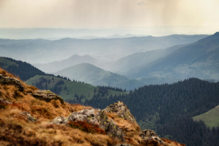 Mountain landscape with layers of hills and misty valleys illustrating the concept time facts in nature.