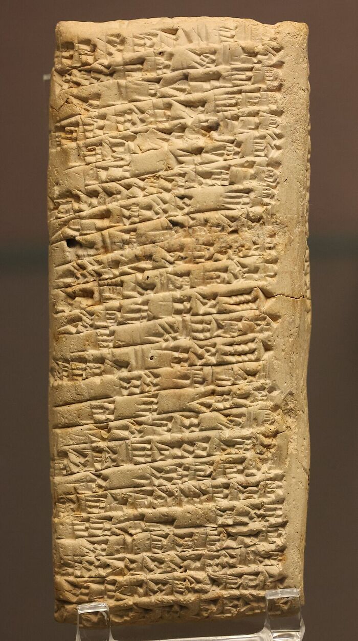 Ancient clay tablet with cuneiform writing representing early concept time facts from historic civilization.
