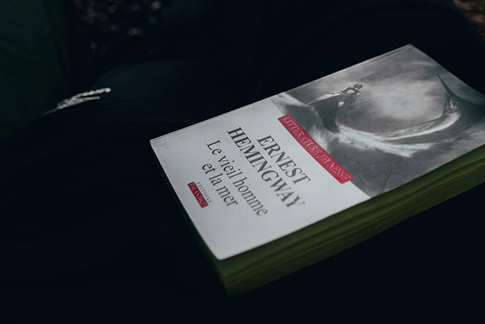 Book titled Le vieil homme et la mer by Ernest Hemingway resting on a dark surface, related to times conspiracy theorists were right.