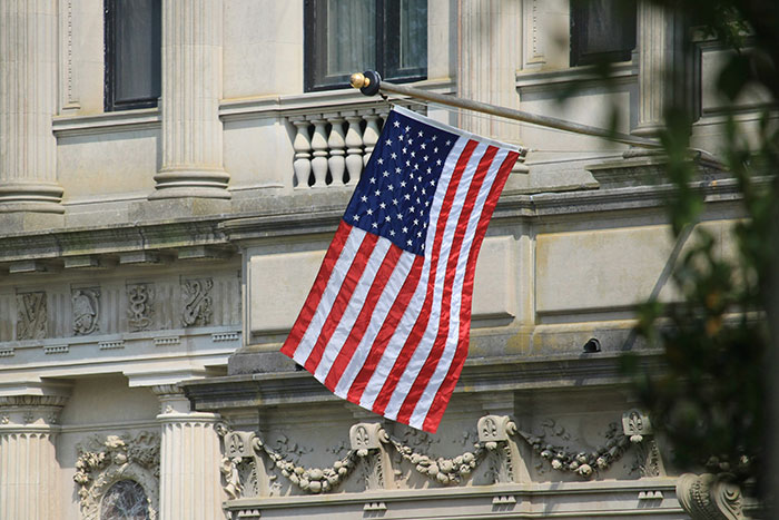 American flag hanging outside a historic building, symbolizing moments when conspiracy theorists were actually right.