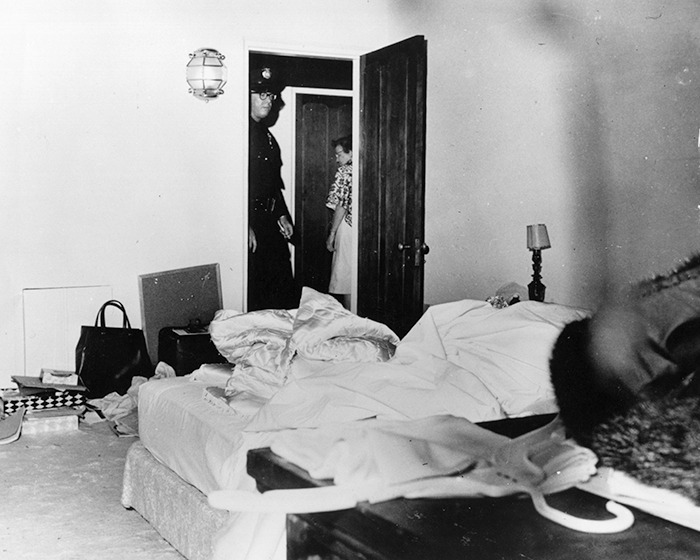 Police officer and woman entering a messy bedroom scene linked to Marilyn Monroe autopsy suspicious finding revealed decades later. - 4