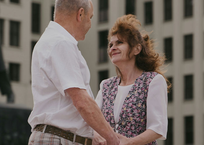 Couple sharing a tender moment outdoors, illustrating the ups and downs of having a partner who went from rags to riches.