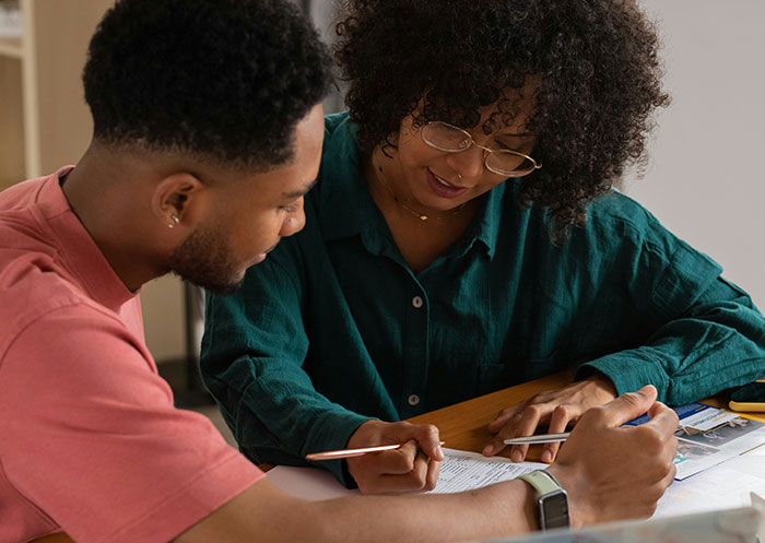 Couple discussing finances thoughtfully, illustrating challenges of having a partner who went from rags to riches.