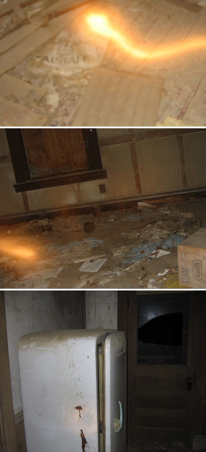 Dimly lit abandoned room with debris and an old rusty refrigerator, evoking creepy vibes in a forgotten place.