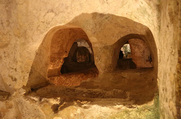 Ancient underground cave with arched openings, evoking creepy vibes and mysterious places people visited.