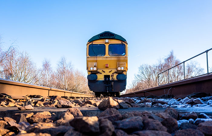 Front view of a train on tracks with rocks, illustrating creepy parts of jobs involving driving over humans.