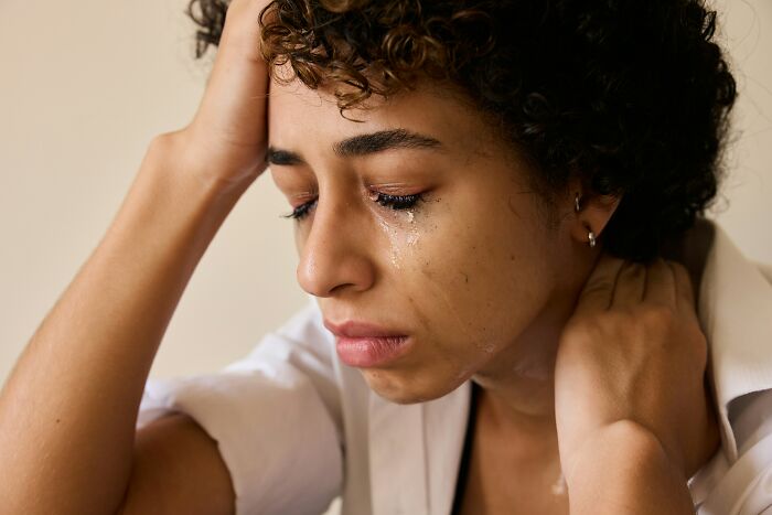 Young woman crying with tears on her face, emotional after discovering dad cheating texts on her phone. - 29