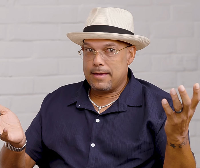 Man wearing a white hat and glasses with a confused expression, related to Halle Berry trolls ex-husband news.