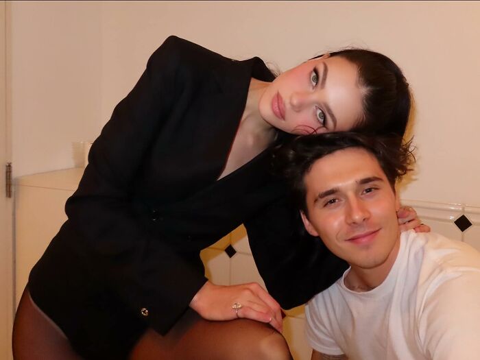 Young couple posing indoors, related to David and Victoria Beckham heartbroken over Brooklyn's vow renewal speech.