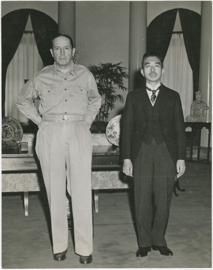 Two men standing in a formal room, one in military uniform and the other in a suit, captured in an iconic moments history photo.
